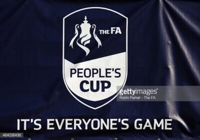 FA People's Cup logo banner at Bishop Auckland FC stadium, promoting community football events and inclusive sports participation, with emphasis on grassroots football and local engagement.
