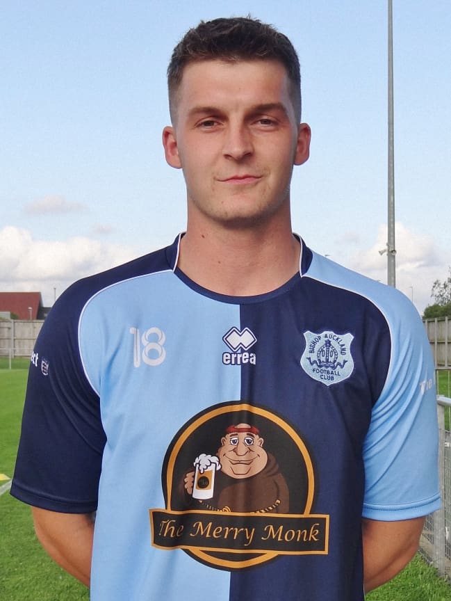 Bishop Auckland FC player in team kit on the football field.