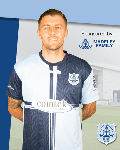 Bishop Auckland FC player in home kit, showcasing team branding and sponsorships, promoting community football and local sports pride in County Durham.