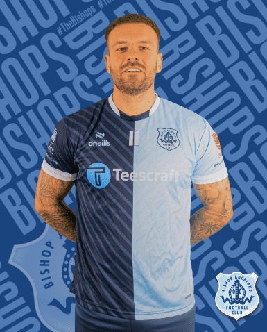 A professional football player wearing Bishop Auckland FC kit stands confidently in front of a blue background with club branding.