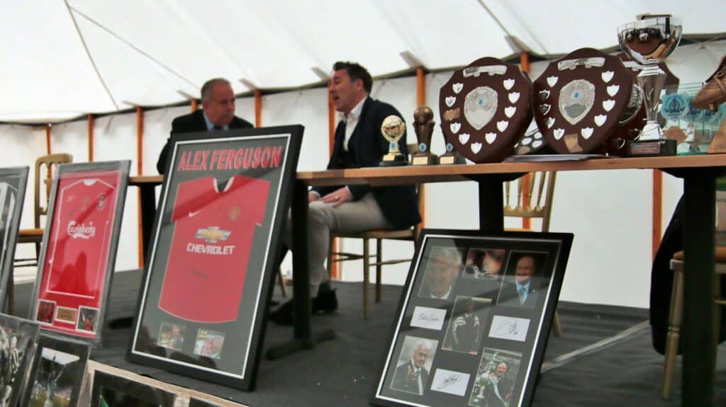 Autographed football memorabilia and trophies displayed at Bishop Auckland FC awards event.