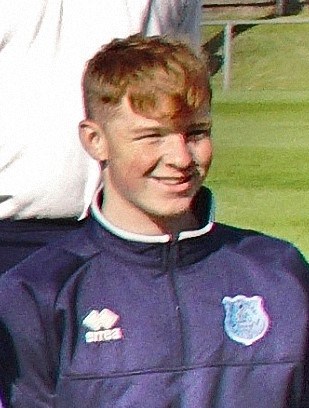 Young football player at Bishop Auckland FC training session, showcasing the youth development and community focus of the club.