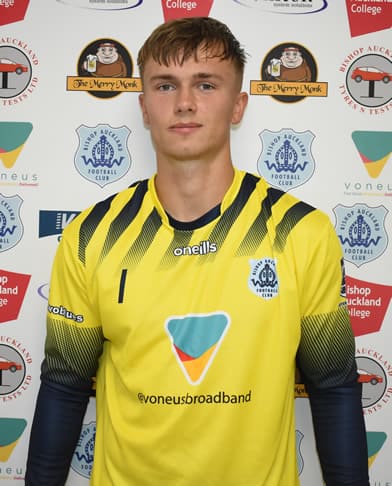 High-performance Bishop Auckland FC goalkeeper in a yellow and black kit during match or event appearance.