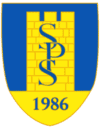 Bishop Auckland FC crest featuring a blue and yellow shield with the club's founding year 1986 and central initials SPS.