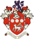 Shield of Bishop Auckland FC featuring a red background, a white goat holding a cross keys, flanked by floral motifs, symbolising the club's heritage and dedication to local community football.