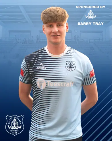Young Bishop Auckland FC player in team kit with sponsorship branding, standing inside a sports facility, promoting the football club and local sports sponsorship.