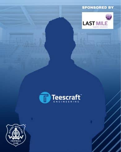 Silhouette of a football player against the Bishop Auckland FC stadium background, showcasing the team's sports environment and community spirit.