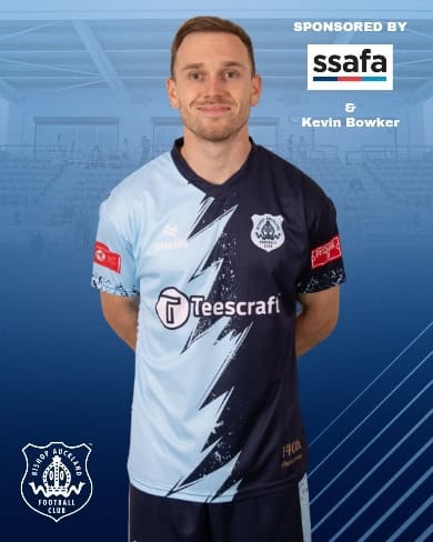 Kevin Bowker in Bishop Auckland FC kit, promoting sponsor support and team branding for Bishop Auckland Football Club, a renowned non-league football team in County Durham.