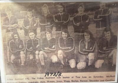 1950s black and white team photo of Bishop Auckland FC players posed outdoors, with some kneeling and others standing, showing historic football team in vintage uniforms, emphasizing club's long-standing football heritage.