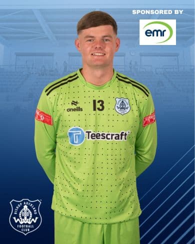 Bright green Bishop Auckland FC goalkeeper kit featuring sponsor logos, with player number 13, set against a blue background with club branding and sponsorship details.